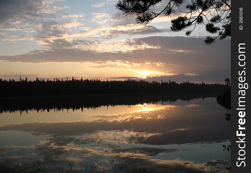 Dawn in a pine wood with a kind on one of lakes of Kareliya. Dawn in a pine wood with a kind on one of lakes of Kareliya.
