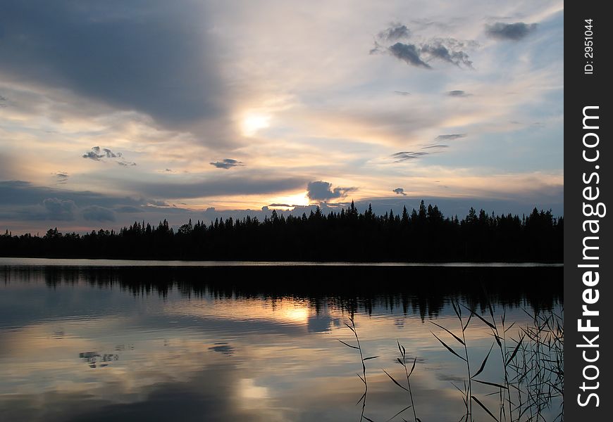 The photo was done on lakes of Kareliya in the early morning. The sun rose through dense clouds is has given photos a steel shade. The photo was done on lakes of Kareliya in the early morning. The sun rose through dense clouds is has given photos a steel shade.