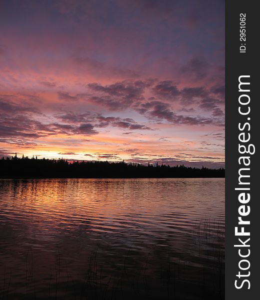 The dawn of unusual pink color photographed on lake near island Olan in the Kareliya. The dawn of unusual pink color photographed on lake near island Olan in the Kareliya.