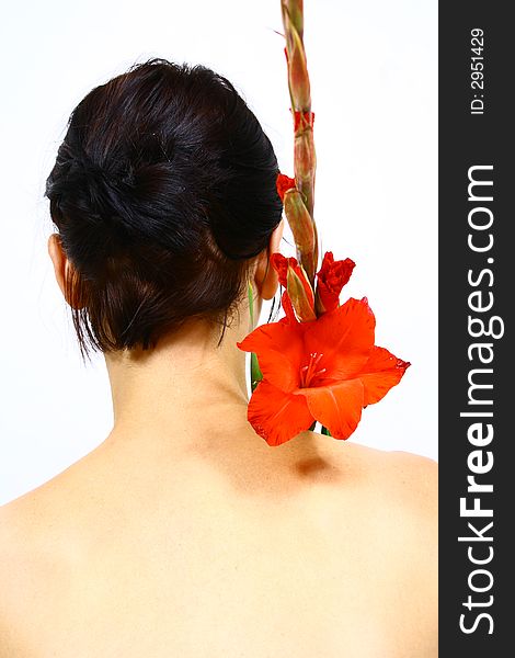 Back of a young woman with a flower and. Back of a young woman with a flower and