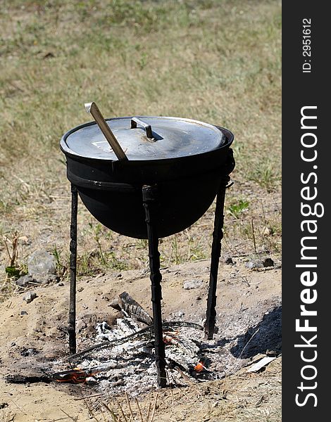 Preparation of a dinner in the big saucepan on a fire. Preparation of a dinner in the big saucepan on a fire