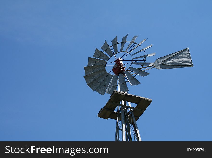A farm windmill made out of galvanized metal to last the ages. A farm windmill made out of galvanized metal to last the ages