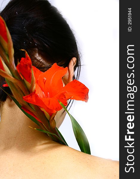Back of a young woman with a flower and black hair. Back of a young woman with a flower and black hair