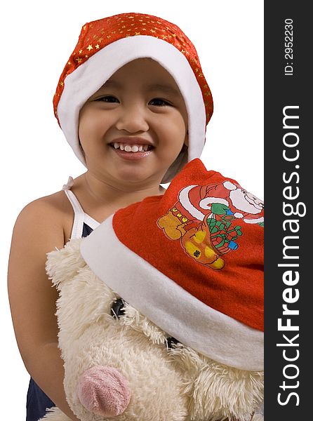 Young girl and teddy bear wearing santa hat. Young girl and teddy bear wearing santa hat