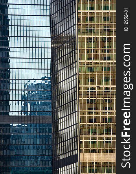 Tall skyscrapers or office blocks with gold and blue windows