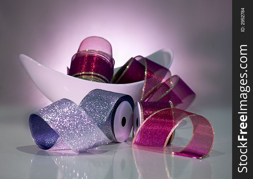 Bowl of ribbon on table setting with mood lighting