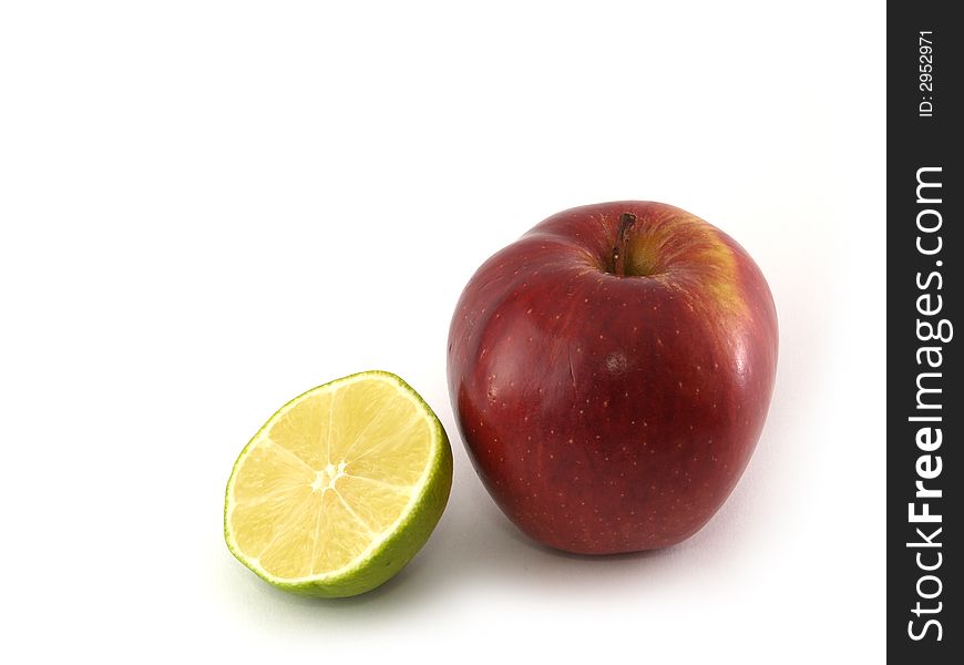 An apple variety called Red Cheaf and half of lime isolated on white. An apple variety called Red Cheaf and half of lime isolated on white.