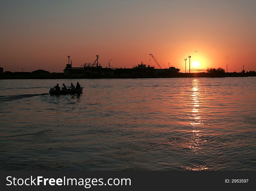 Sunrise on the Danube river, Sulina branch, with a building yard on the background. Sunrise on the Danube river, Sulina branch, with a building yard on the background