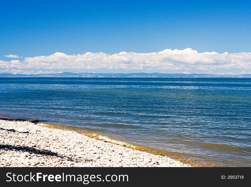 Baikal lakeside with mountains of Olhon island on skyline (lake Baikal - first-rate reservoir of unadulterated sweet water, it contains about 1/4 of all world's reserve)