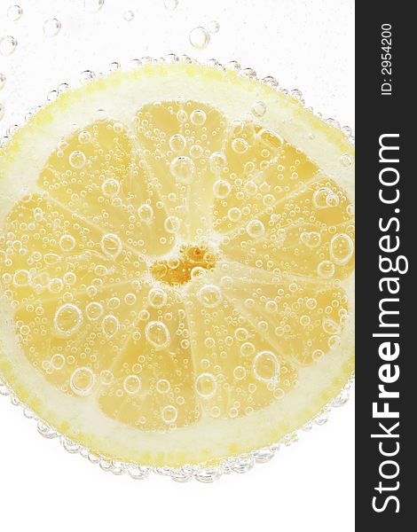 Lime slice on a bright white background whit water bubbles. Lime slice on a bright white background whit water bubbles