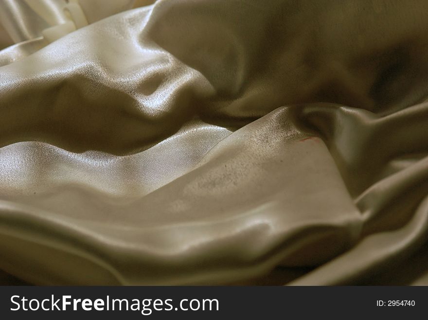 Soft folds of glistening satin fabric make for abstract mountainous background. Soft folds of glistening satin fabric make for abstract mountainous background