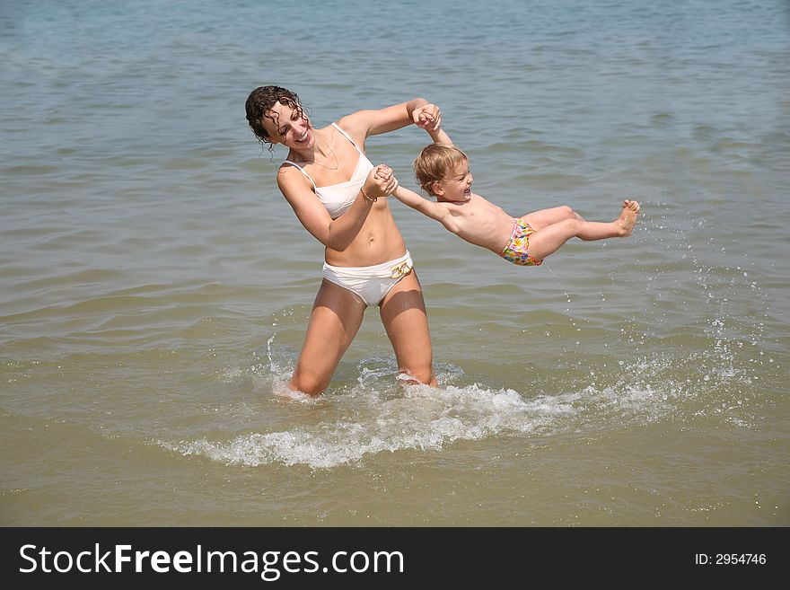Mum and daughter have a good time in the sea. Mum and daughter have a good time in the sea