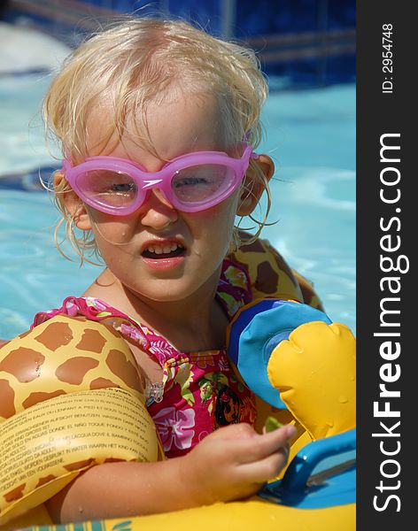 A kid in goggles in the pool