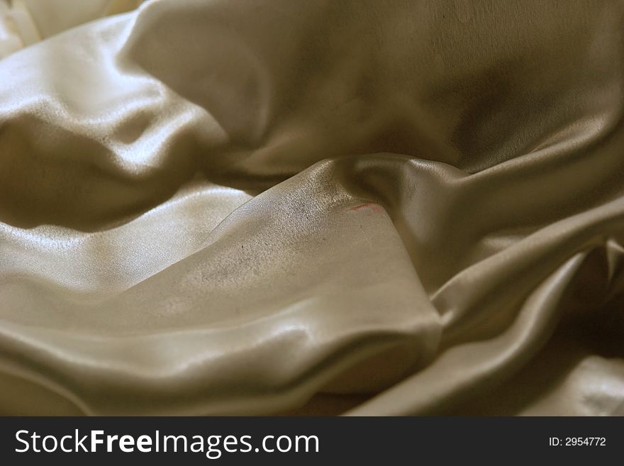 Soft folds of glistening satin fabric make for abstract mountainous background. Soft folds of glistening satin fabric make for abstract mountainous background