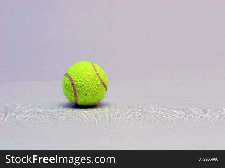 Tennis ball with a detailed racquet lying on it