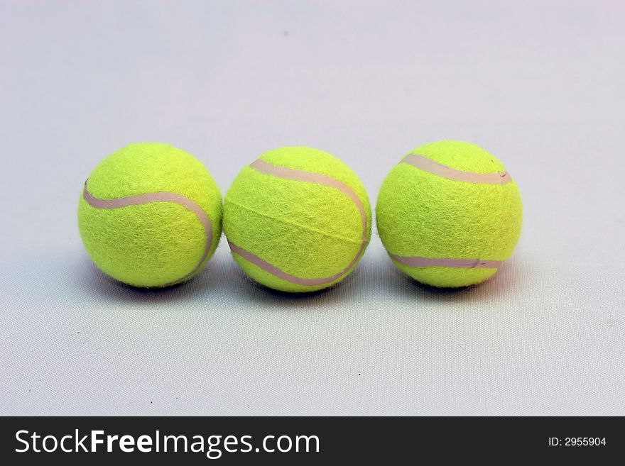 Tennis ball with a detailed racquet lying on it