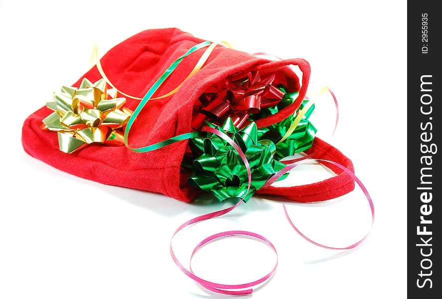 Festive ribbons and bows as used in wrapping gifts for holiday or birthday and red bag. Festive ribbons and bows as used in wrapping gifts for holiday or birthday and red bag