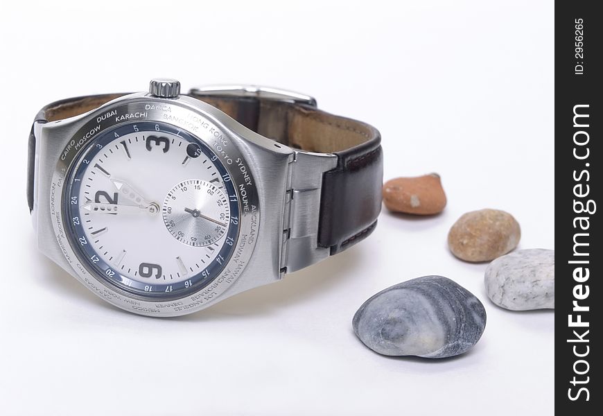 Modern watch and little rock