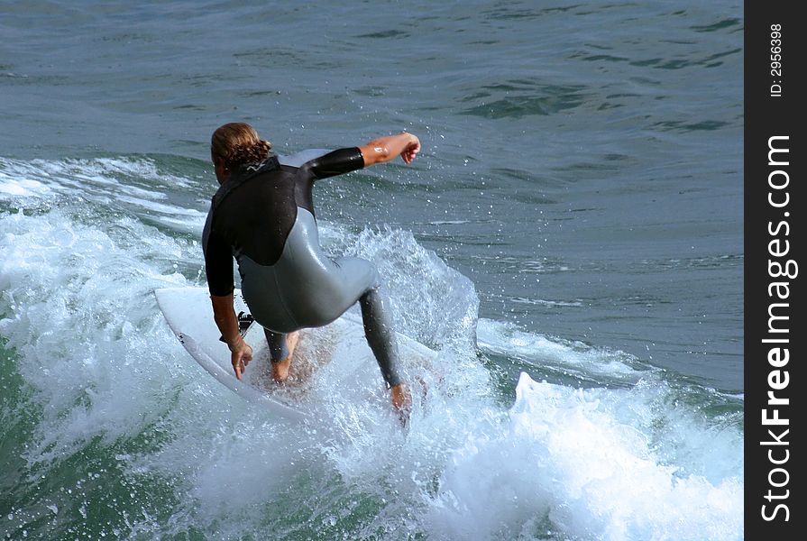 Close up of a male surfer catching a wave.