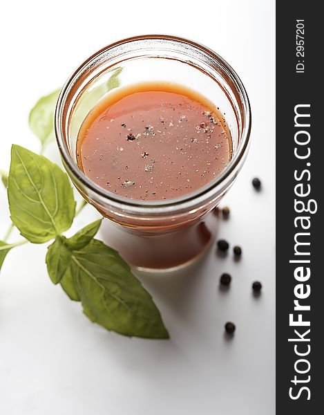 Tomato juice with green sweet basil and pepper