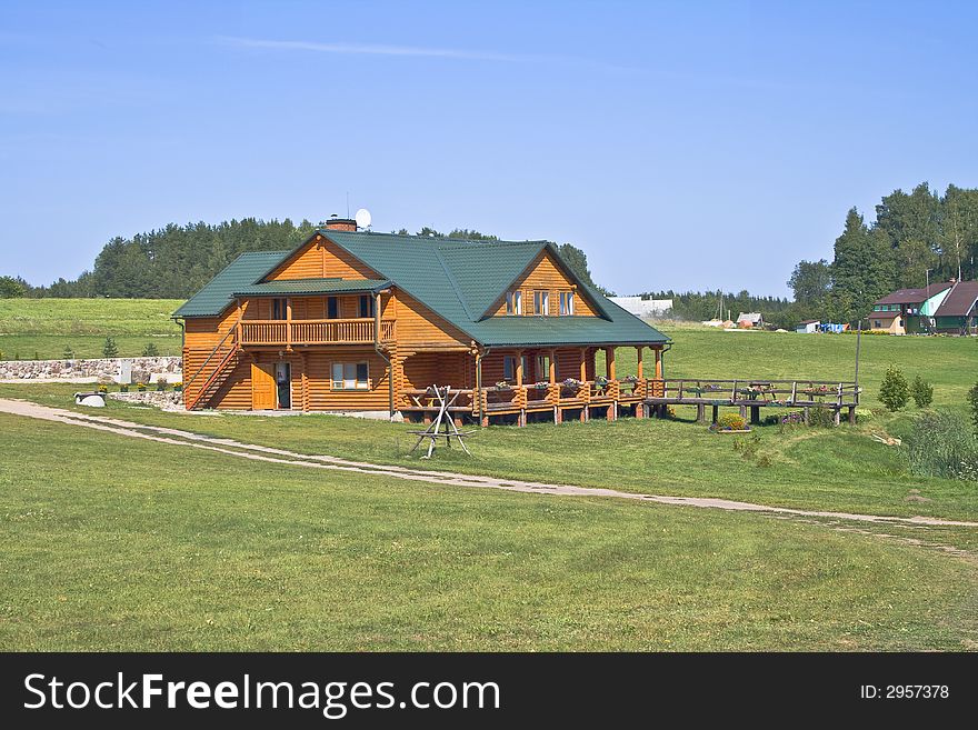 House in grassy foreground with flowers