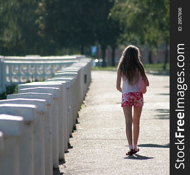 The girl walks on quay. The girl walks on quay