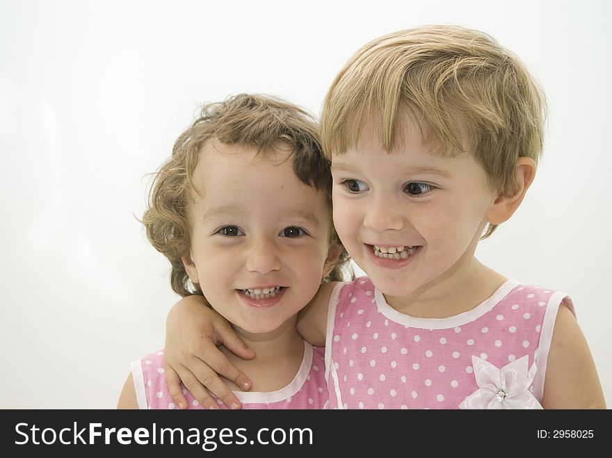 Twins sisters smiling and posing in the studio