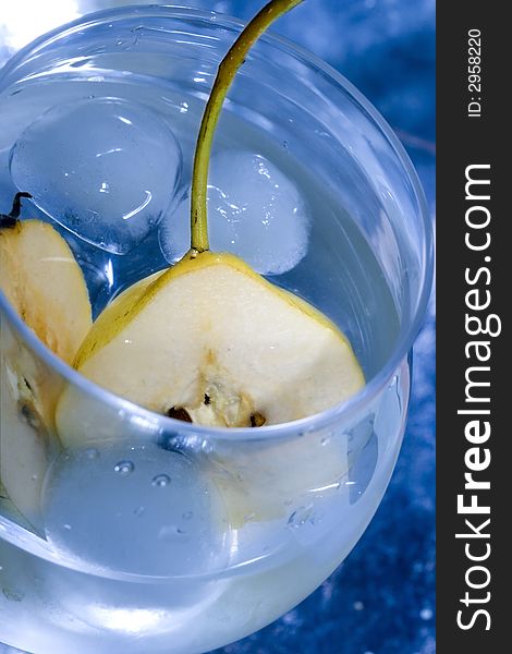 Pear in glass with martini and ice