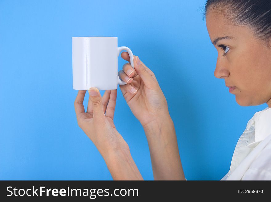 Young girl holding cup on blue background