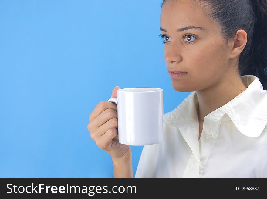 Young girl holding cup on blue background. Young girl holding cup on blue background