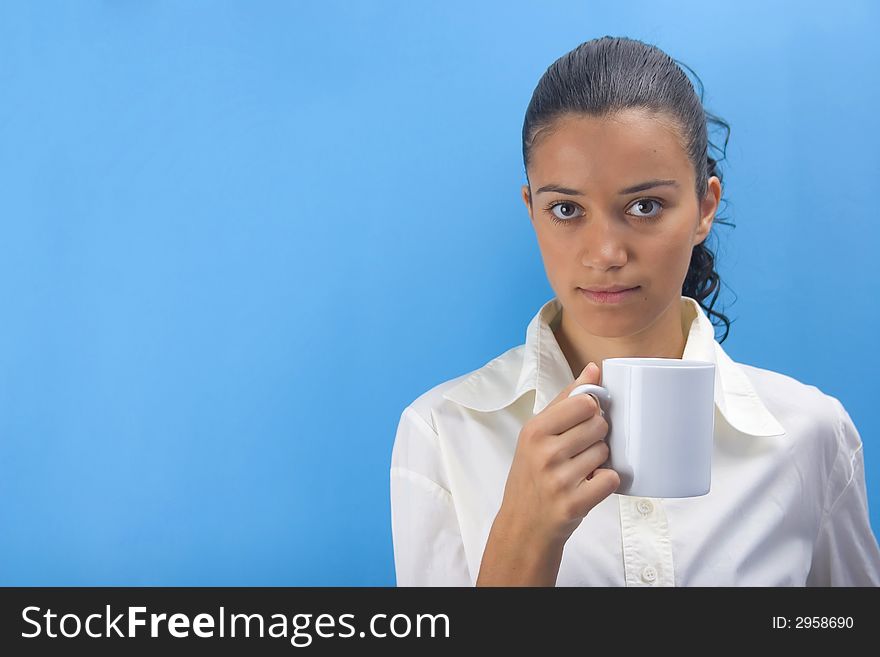 Young girl holding cup on blue background