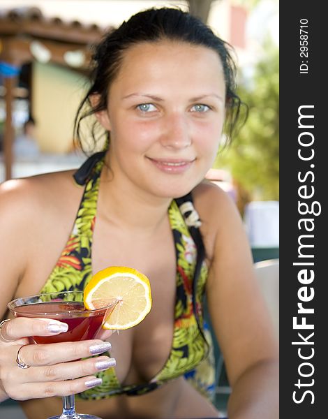 Young beautiful smiling woman with a cocktail. Young beautiful smiling woman with a cocktail