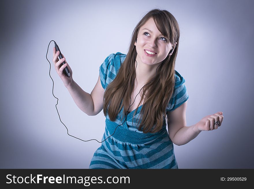 Cute young female hearing music from an mp3 player. Cute young female hearing music from an mp3 player