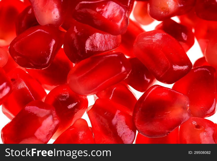 Background of the red juicy pomegranate seeds closeup. Background of the red juicy pomegranate seeds closeup