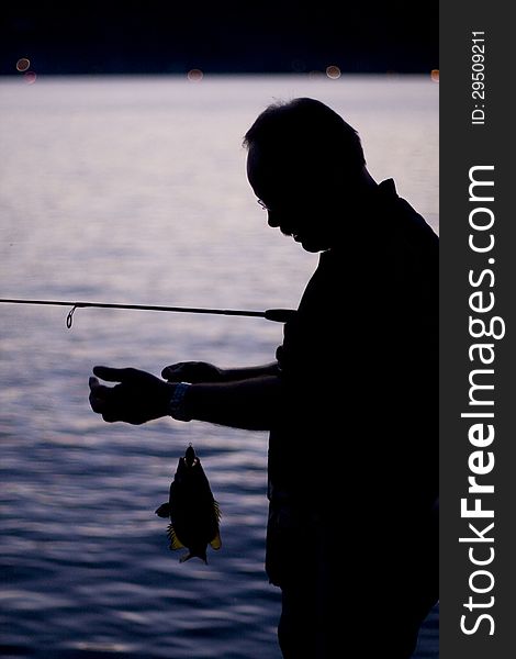 Man fishing at sunset on Keuka Lake in upstate New York