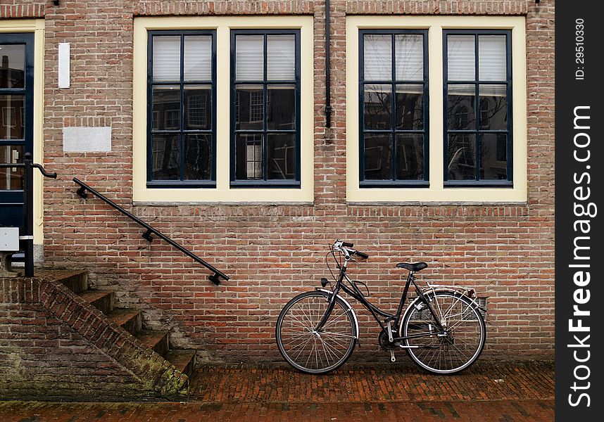 A classic bicycle against brick wall at streets of Middelburg, Netherlands. A classic bicycle against brick wall at streets of Middelburg, Netherlands.