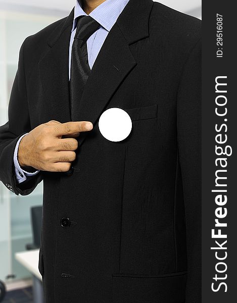 Man with black business suit with blank pinned button. You can put your design on the button. Election day background or concept. Man with black business suit with blank pinned button. You can put your design on the button. Election day background or concept