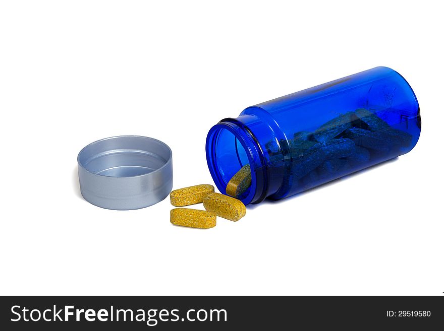 Nice horizontal close up shot of a blue bottle laying on its side and spilling healthy vitamins. on a white background. Plenty room for copy space. Nice horizontal close up shot of a blue bottle laying on its side and spilling healthy vitamins. on a white background. Plenty room for copy space.