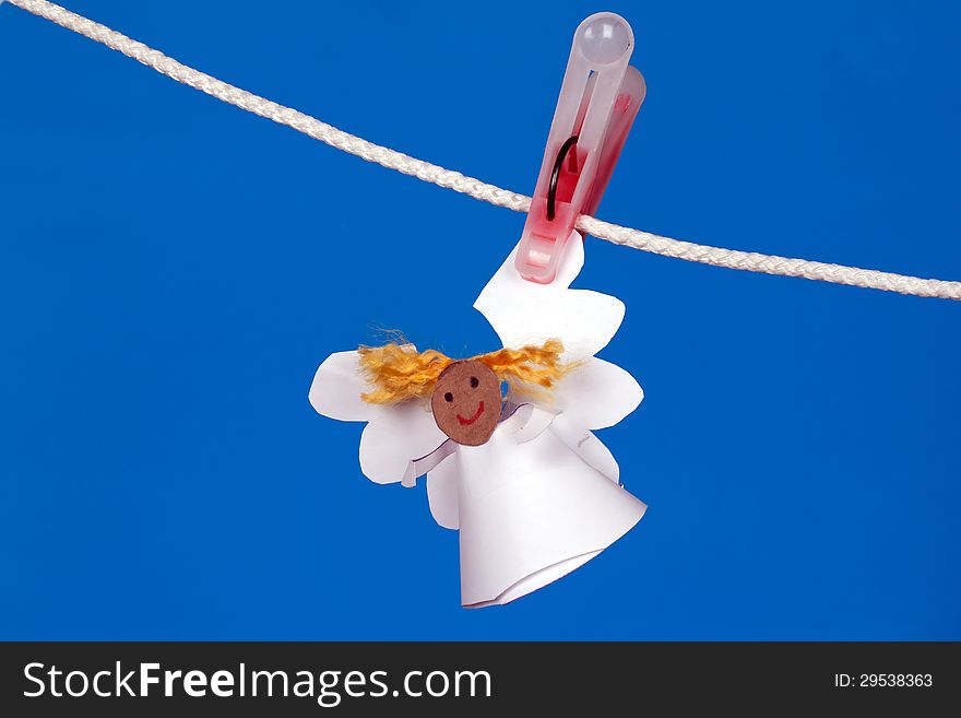 Angel made of paper hanging on a rope