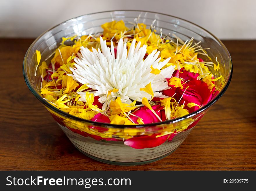 Chrysanthemum with petals in a vase with water. White, red and yellow flowers.