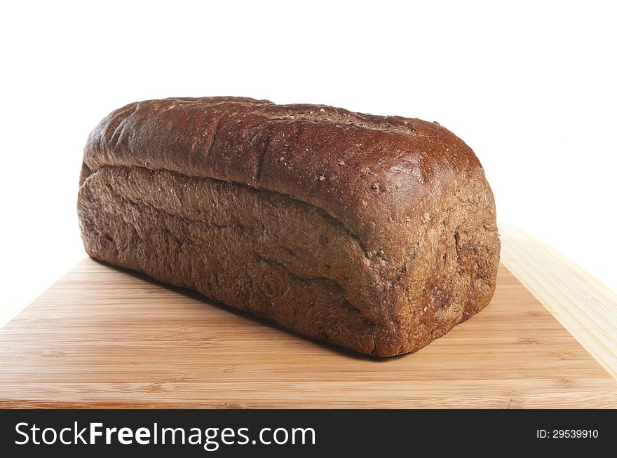 Freshly baked whole wheat bread cooling on the cutting board. Freshly baked whole wheat bread cooling on the cutting board