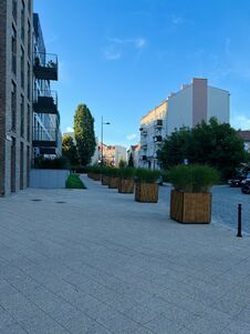 Gdansk, Poland - 08.08.2022: A Modern Residential Area In The City Center, A Pedestrian Zone Made Of Tiles, Cubic Flowerpots With Royalty Free Stock Photos Gdansk, Poland - 08.08.2022: A Modern Residential Area In The City Center, A Pedestrian Zone Made Of Tiles, Cubic Flowerpots With Royalty Free Stock Photos