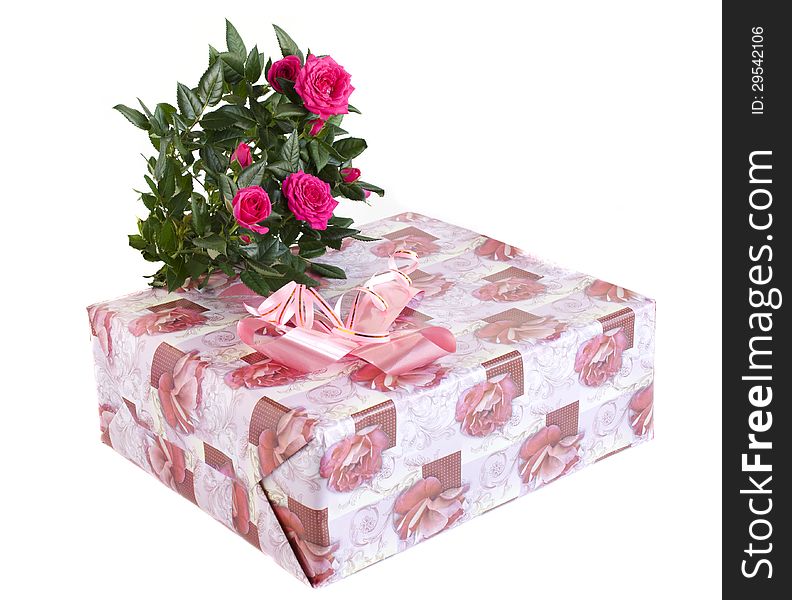 Box with a gift and bouquet of roses on a white background