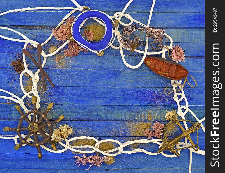 Nautical objects made of clay with white rope on the blue wooden background. Nautical objects made of clay with white rope on the blue wooden background