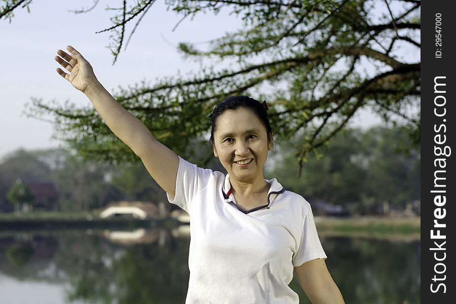 Happy woman smiling carefree and joyful in beautiful park. Happy woman smiling carefree and joyful in beautiful park.