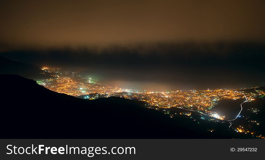 Night landscape from mountain top on the city on the seashore, panorama. Night landscape from mountain top on the city on the seashore, panorama