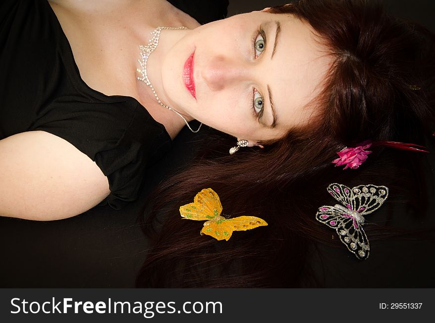 Portrait of European woman with butterflies on the hair