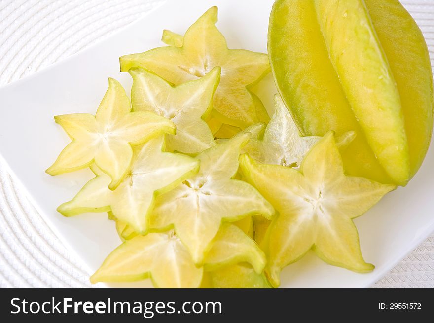 Sliced carambola on white plate. Sliced carambola on white plate