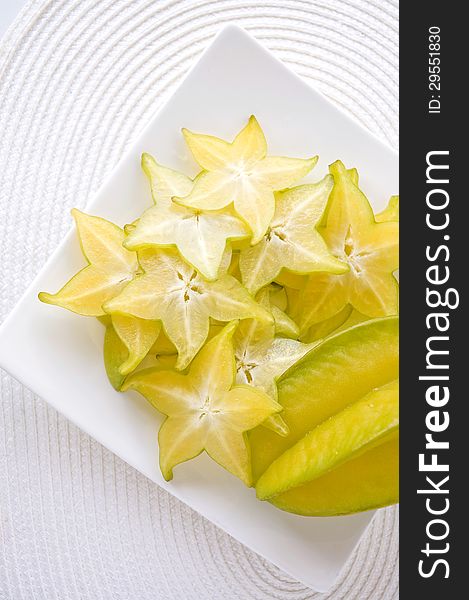 Sliced fresh starfruit serve on white plate. Sliced fresh starfruit serve on white plate