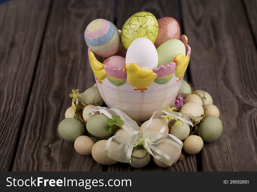 Easter eggs in a bowl and on a wooden table. Easter eggs in a bowl and on a wooden table.